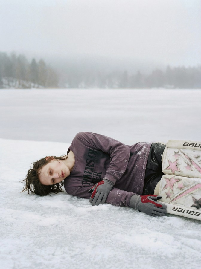 AI-created goalkeeper lying on his side on the frozen lake
