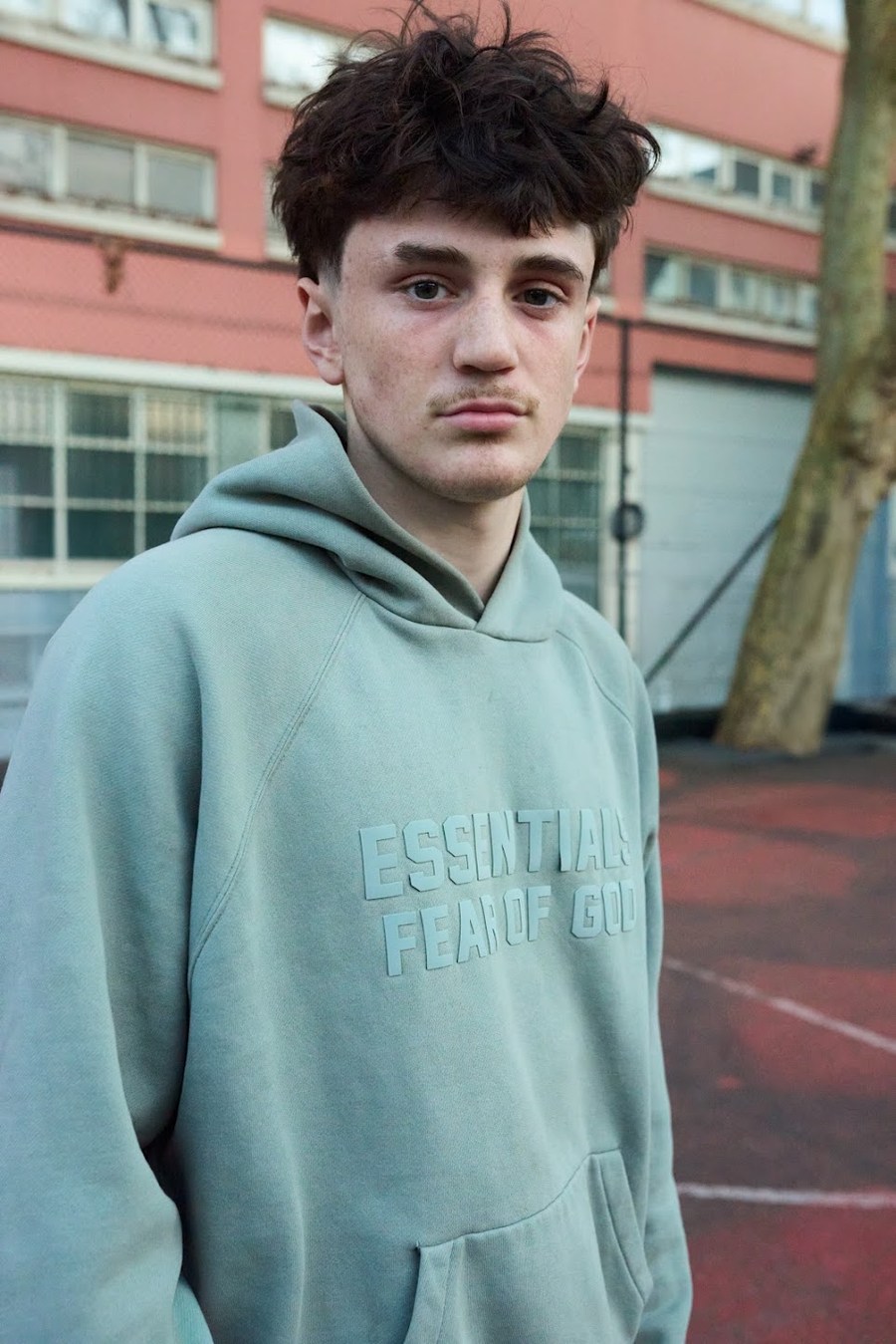 Close portrait in a pale green hoodie at Quai de Jemmapes