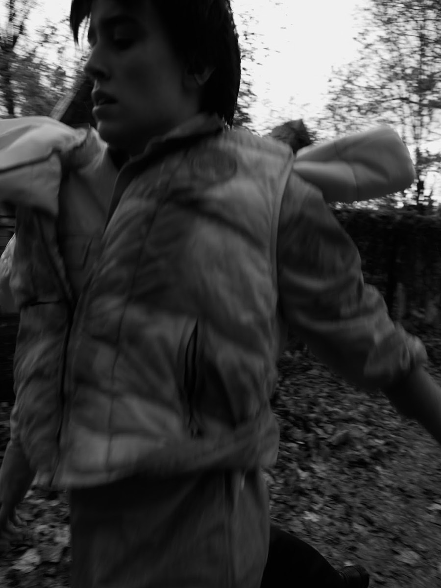 Close portrait in woodland wearing a padded vest