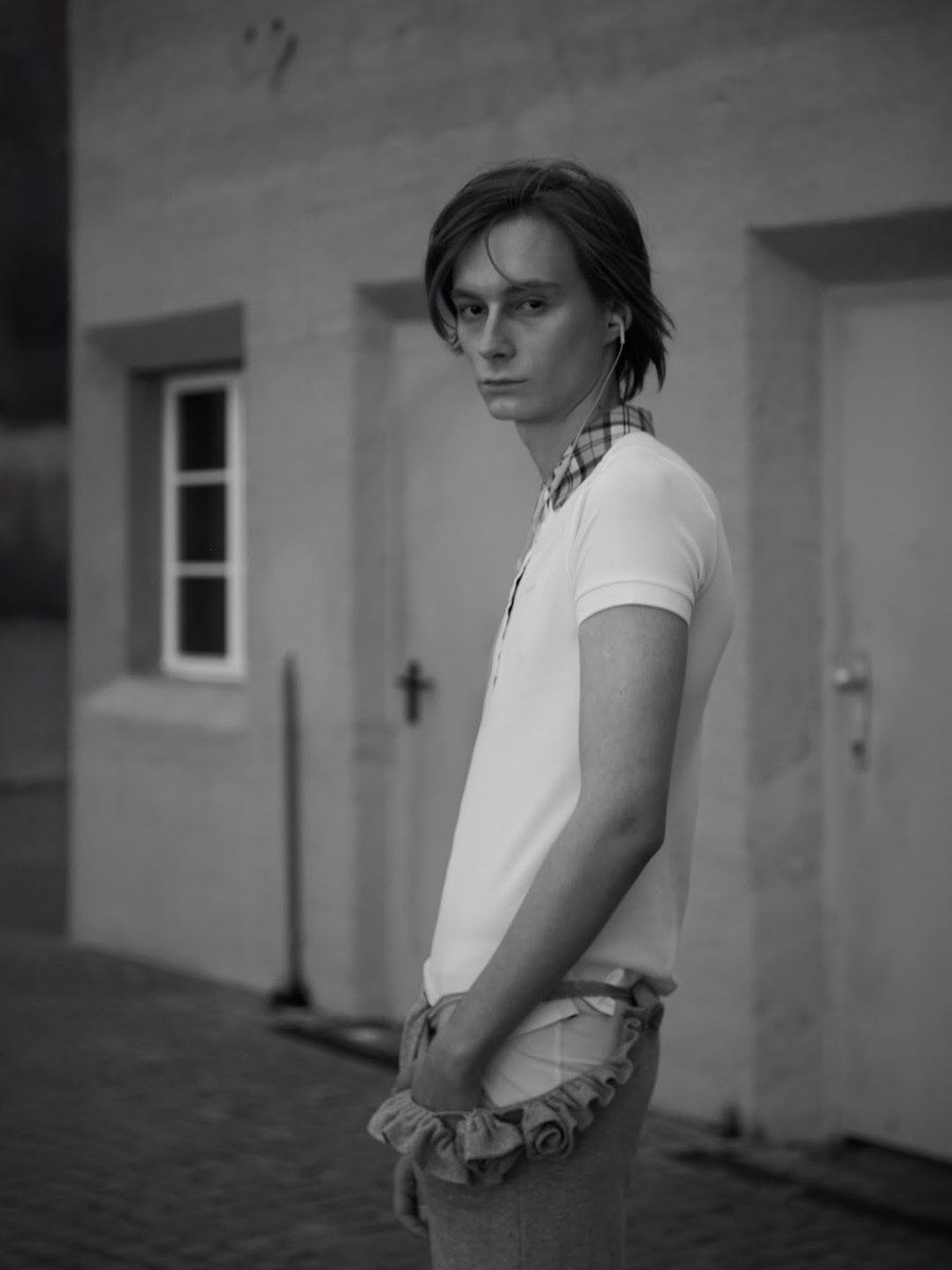 Portrait in a white polo shirt outside a building