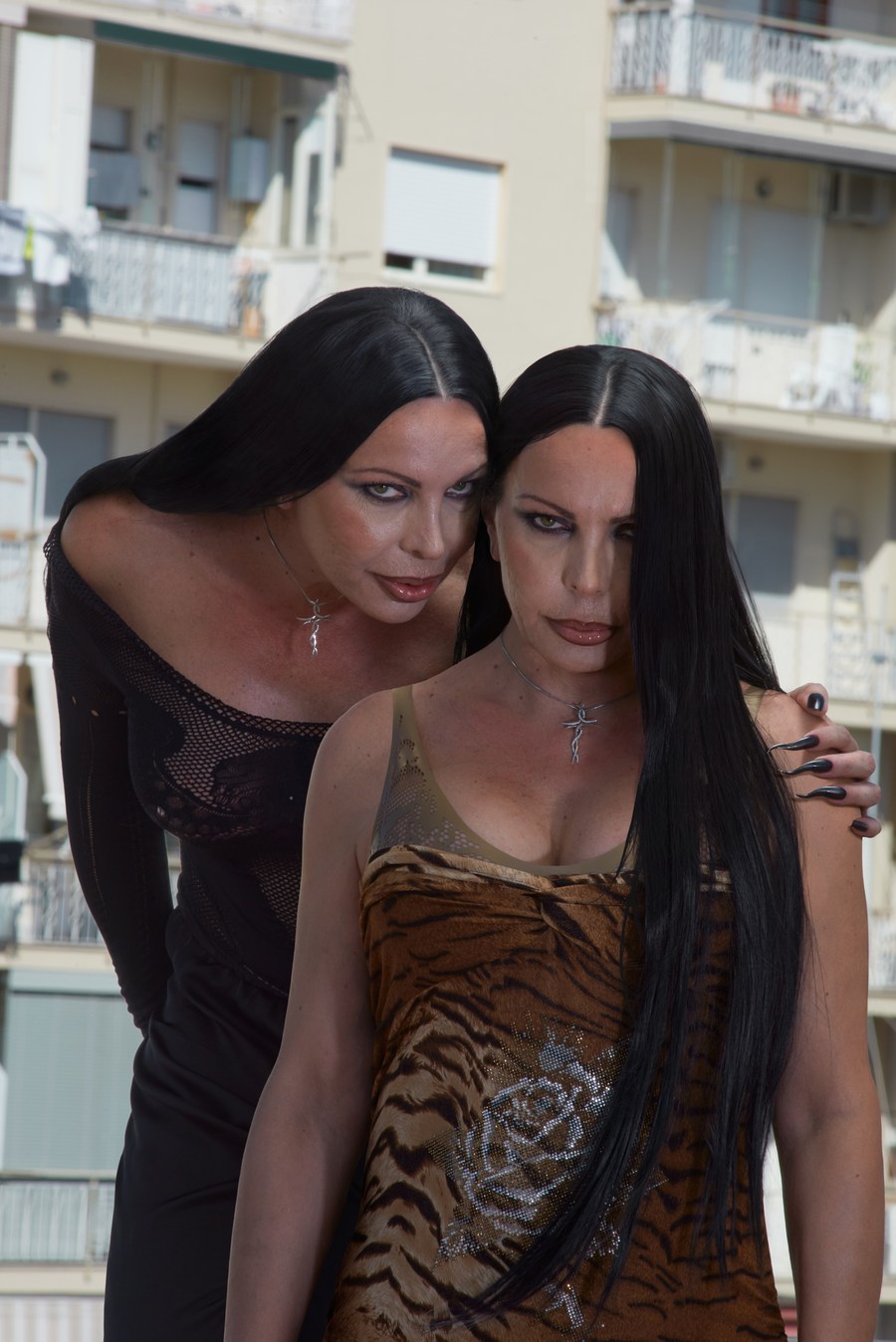 Two women leaning together for an outdoor portrait