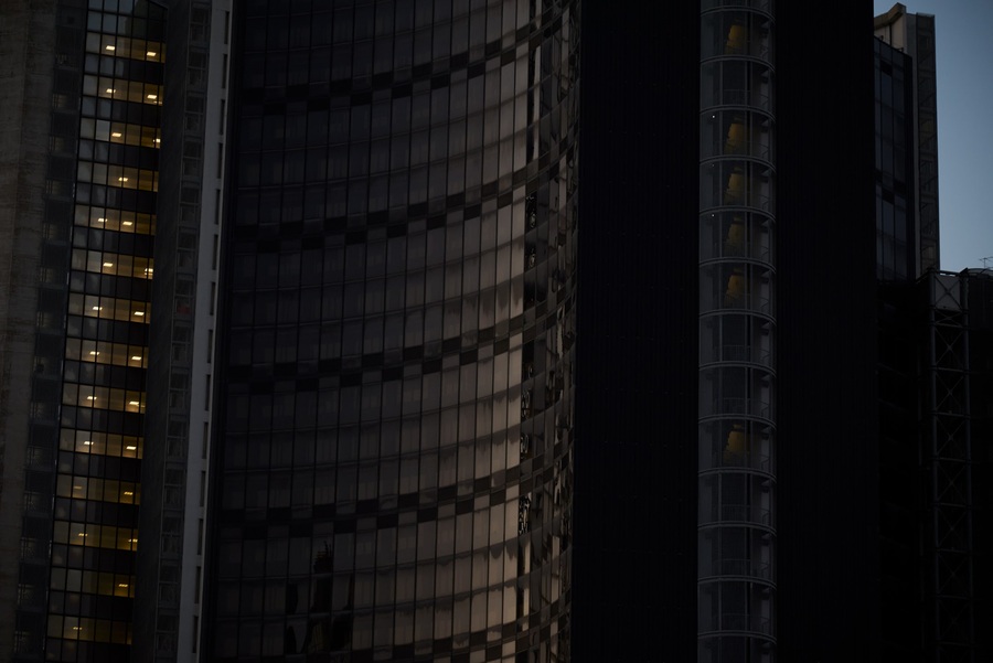 Residential towers at dusk, with illuminated windows
