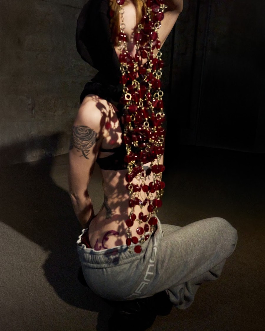 Model seen behind hanging red jewels